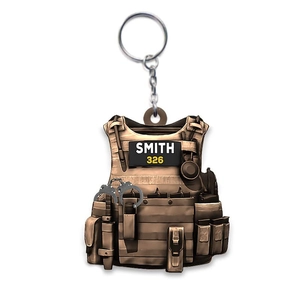 Detailed close-up of a bronze tactical vest keychain with Smith engraving and mini handcuffs