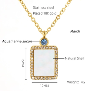 Detail of 18K gold plated necklace featuring natural shell and aquamarine zircon stones