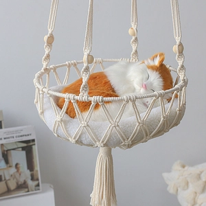 Bohemian macrame cat hammock with white plush cushion and wooden bead accents
