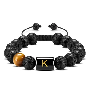 Detailed close-up of the black volcanic stone beads and golden letter K on the tiger eye stone charm