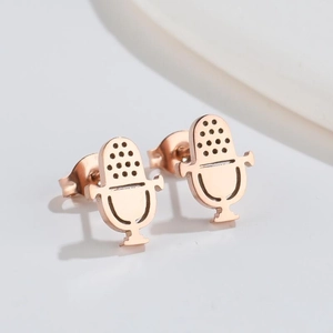 Close-up of rose gold microphone-shaped stud earrings in polished stainless steel