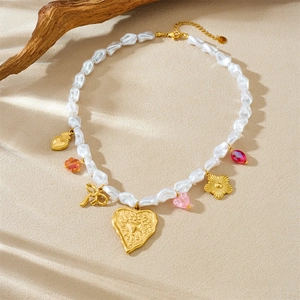 Faux pearl heart flower bow stainless steel necklace on a natural textured background