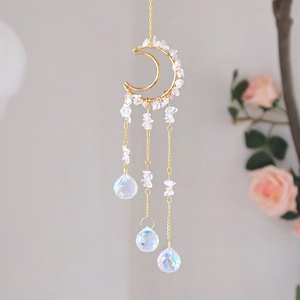 Close-up of golden moon suncatcher with crystal stones and iridescent prism balls