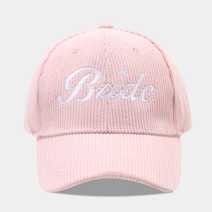 Close-up of Bride embroidery on pink corduroy baseball cap with velvet texture