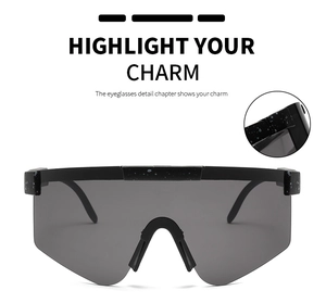 Detail view of large cycling sunglasses with black polka dot frame and dark gray lenses