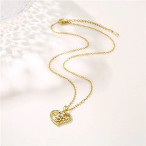Gold stainless steel heart necklace with LOVE pendant and zircon stars on light background