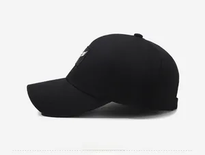 Side view of black cotton baseball cap showing detailed white wing embroidery on the side