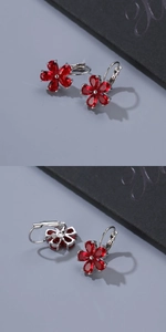Macro detail of red petal-shaped zircon earrings with secure silver-plated leverback hooks