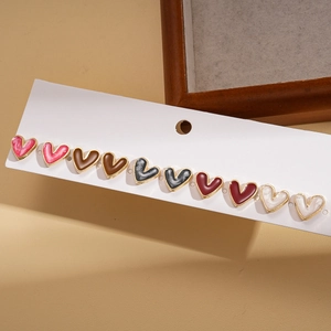 Macro detail of ten-piece heart stud earring set with gold edges in five colors