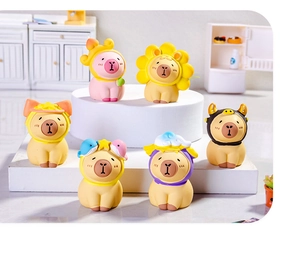 Detailed view of six miniature Capybara resin figurines in a bright dollhouse kitchen