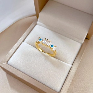 Adjustable gold plated evil eye ring with rectangular zircon stones in a jewelry box