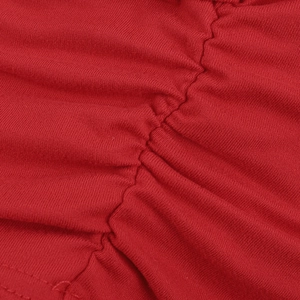 Macro detail of red knitted fabric featuring ruched texture and intricate stitching