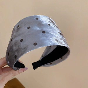Detail showing grey velvet wide headband with dark polka dots and black inner lining