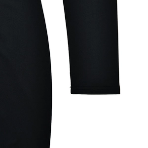 Close-up of sleeve stitching and knitted fabric texture on black high-slit dress