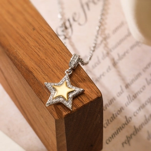 Dual-tone star pendant necklace with gold and silver stars and micro-pave cubic zirconia