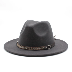 Detailed close-up of dark grey wool fedora with ethnic woven band and leather strap buckle
