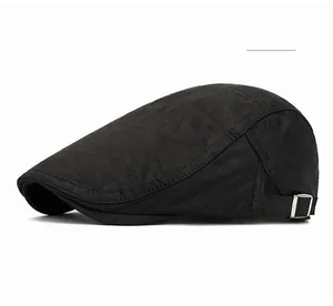Side view of black cotton newsboy cap showing the adjustable silver metal buckle detail