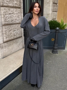 Detailed texture of dark grey knit cardigan and slim dress set on elegant street setting