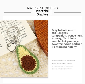 Detail of handmade crochet avocado keychain with green skin and silver lobster clasp