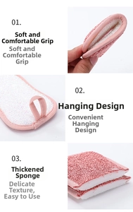 Detail of pink double-sided dish sponge showing hanging loop and thick absorbent layers