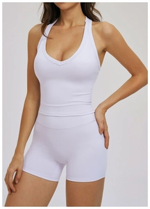 Detail of high-waist yoga shorts and racerback tank top in pale lilac ribbed fabric