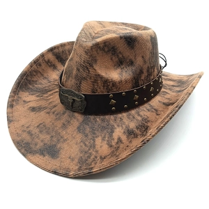 Macro detail of faux suede cowboy hat with marble texture and bull head buckle