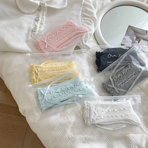 Detail of sweet ruffle trim socks in six colors with ribbon bows and packaging