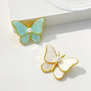Exquisite butterfly brooches with natural mother-of-pearl wings and central pearl accents