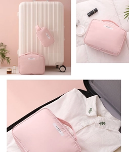 Pink waterproof makeup bag set packed in a white suitcase for travel organization