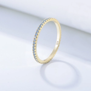 Macro detail of gold S925 silver ring with micro-paved blue zircons and 925 stamp