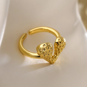 Minimalist gold-plated geometric heart open ring resting on soft white silk fabric