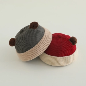 Cute knitted baby beanie with bear ears in grey and red patchwork colors for autumn