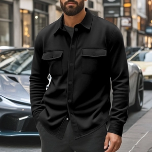 Detail shot of black windproof jacket with dual chest pockets and lapel collar