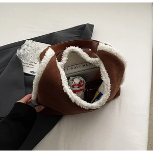 Detail view of large brown suede tote bag interior with white fuzzy trim and spacious capacity
