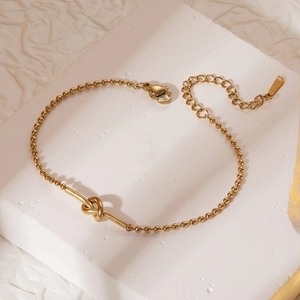 Elegant gold-plated stainless steel ball chain bracelet with central knot design
