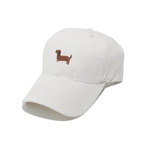 Close-up of cute dachshund dog embroidery on a cream white cotton baseball cap