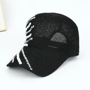 Detail of black baseball cap with sparkling sequins, white pearls and silver rhinestones