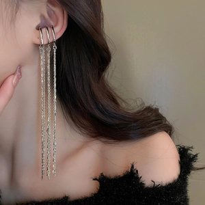 Elegant silver triple-layer long tassel ear clips for women on a stylish model