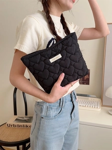 Quilted heart pattern black makeup bag with zipper closure and white woven label tag