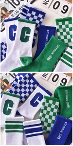 Detail of vintage checkerboard athletic crew socks with C-letter embroidery and stripes