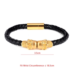 Detail of black braided leather bracelet with gold skulls and magnetic clasp size guide