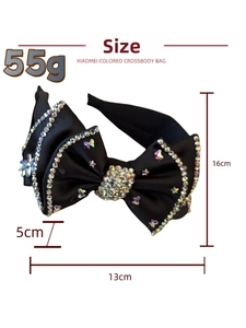 Detail of luxury black satin headband with rhinestone bow measuring 16cm height and 55g