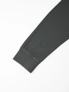 Detail of dark grey ribbed cuffs on long sleeve polo shirt with micro-grid fabric texture