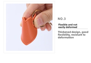 Detail of orange flexible leather keychain with gold ring, showing durable thick material