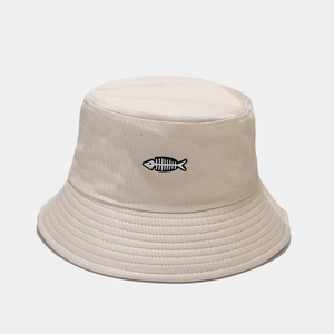 Detailed close-up of fishbone embroidery on beige canvas bucket hat brim and fabric