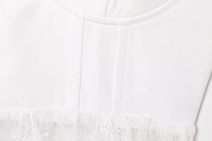 Close-up of white sexy top showing delicate lace stitching and premium fabric texture