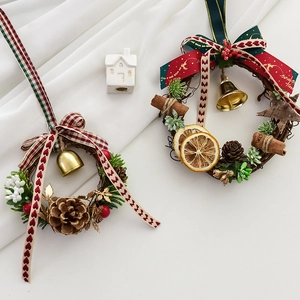 Mini Christmas wreaths with pine cones, cinnamon sticks and bells for festive decor