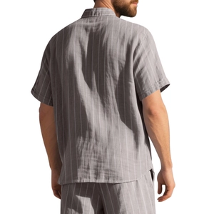 Detail view of men's grey vertical striped linen shirt showing back fit and breathable fabric