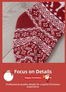 Detail of red Christmas knitted stocking with reindeer patterns and snowflake textures