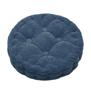 Close-up of thick navy blue corduroy round seat cushion with quilted button design